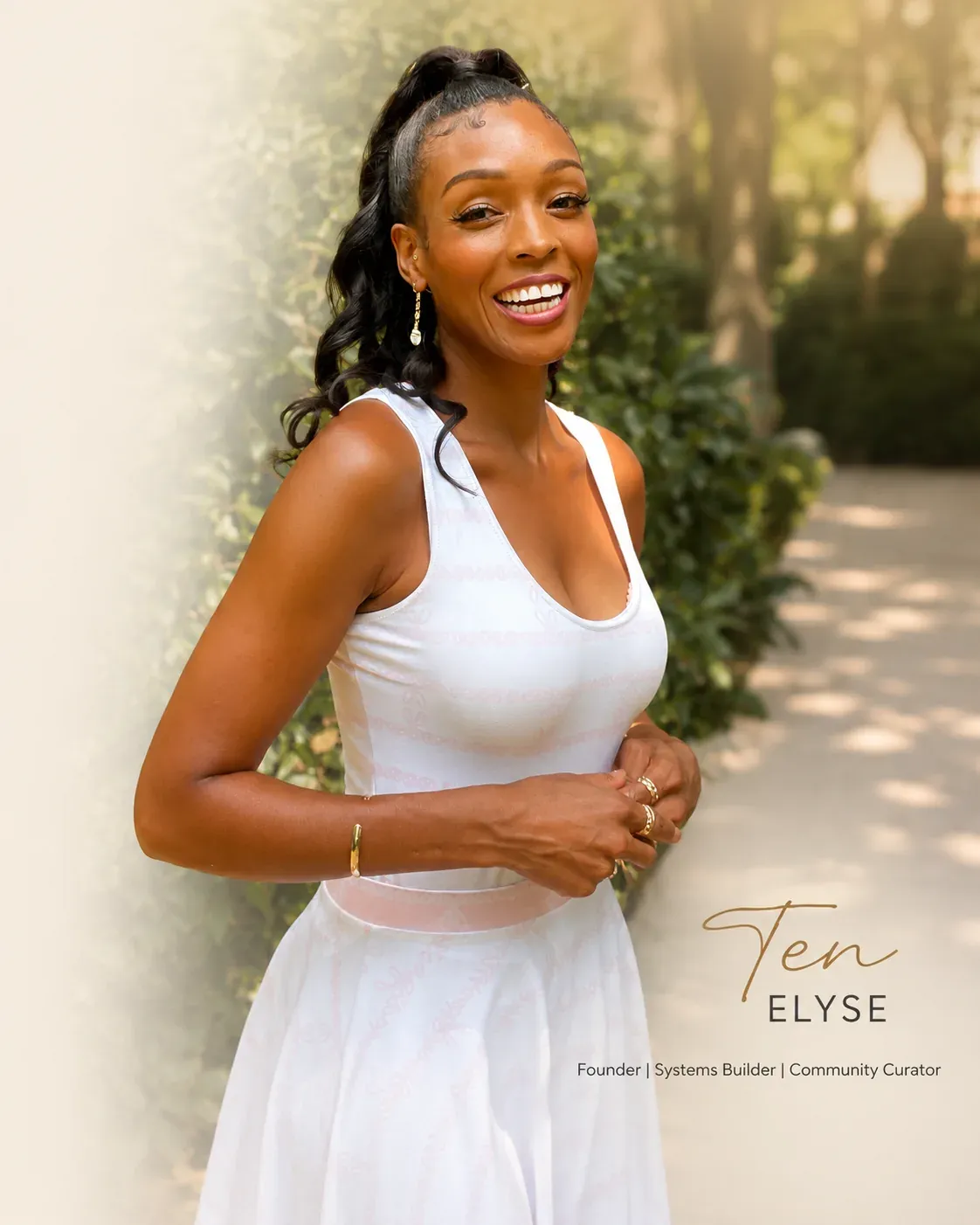 Ten Elyse, Founder, Systems Builder and Community Curator, smiling in a white dress in a sunlit garden